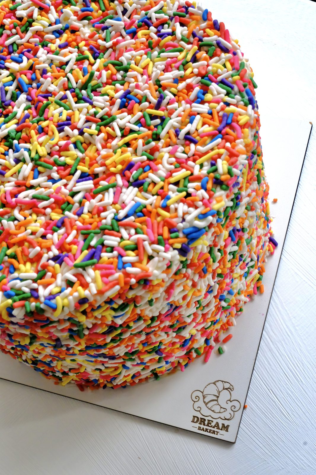 Funfetti cake slices with rainbow sprinkles and cream filling — Dream Bakery