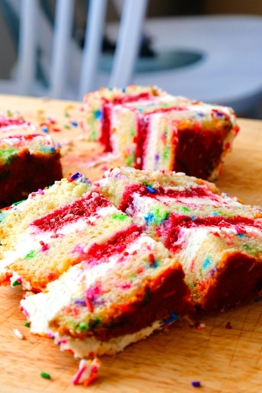 Sprinkle-covered cake on Dream Bakery branded board